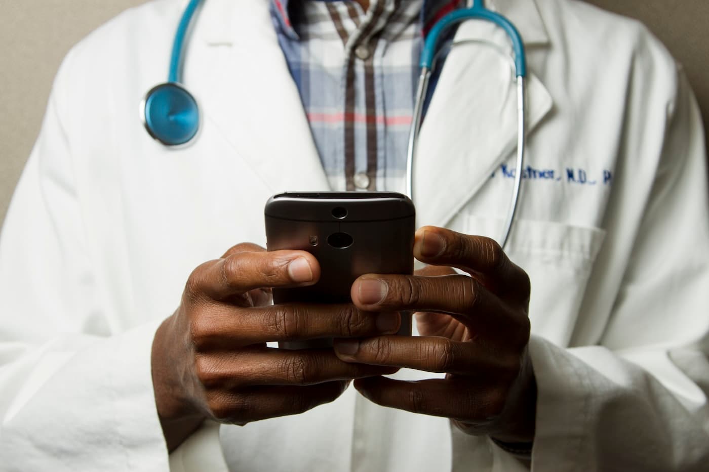 Clinician reviewing the Meridian Health patient app on a smartphone