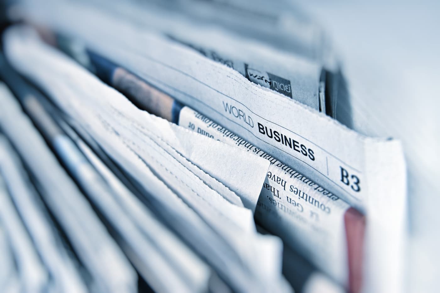 Stack of printed newspapers, representing the Horizon News digital newsroom